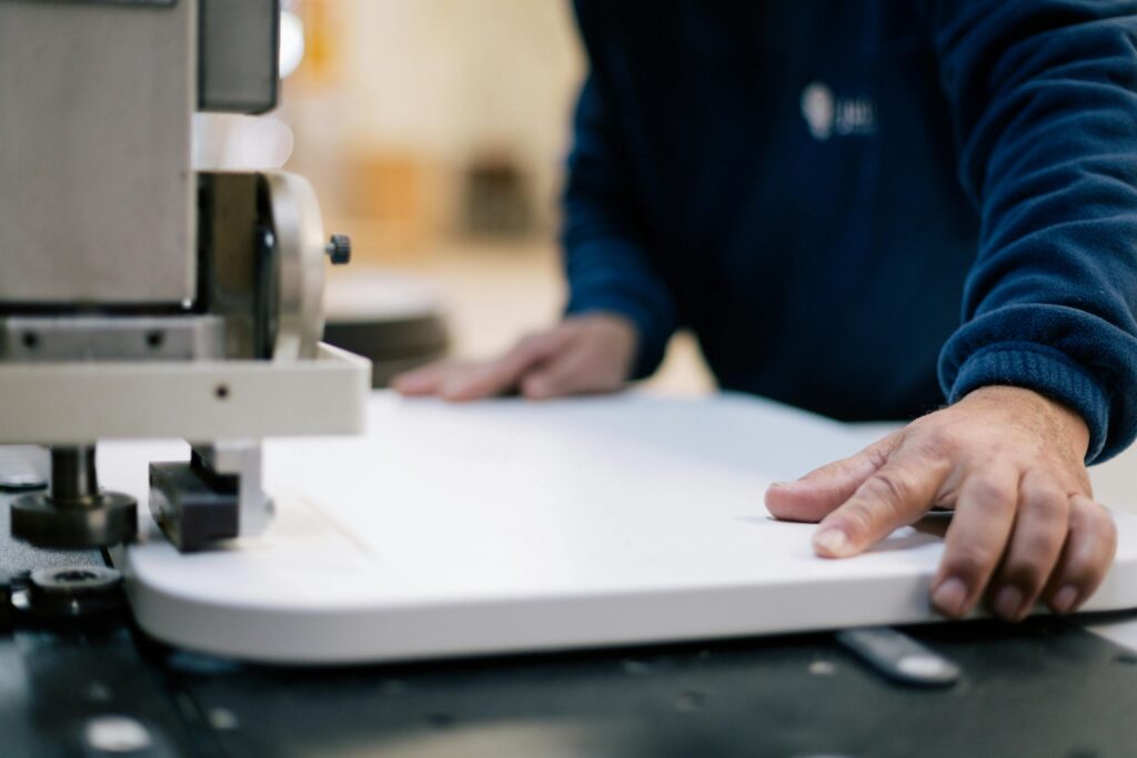 Close-up of a craftsman using machinery for precision woodwork indoors.